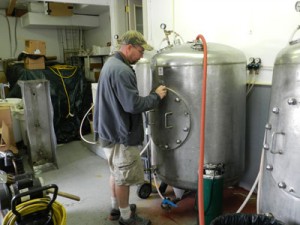Chris Blamer seals a tank of Mount Angel Brewing\'s soda for carbonation.