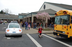 Cars, buses, and kids on foot make for congestion at St. Mary School when classes get out.