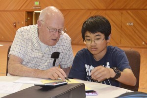 A volunteer assists a student with his homework for After School Activities Program.