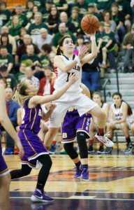 Lakin Susee takes flight. Left, the JFK girls celebrate their victory. Photo by Beth Stafford.