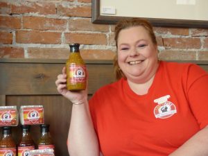 Tyna Mays-Schey with one of her Saucy Minx sauces.