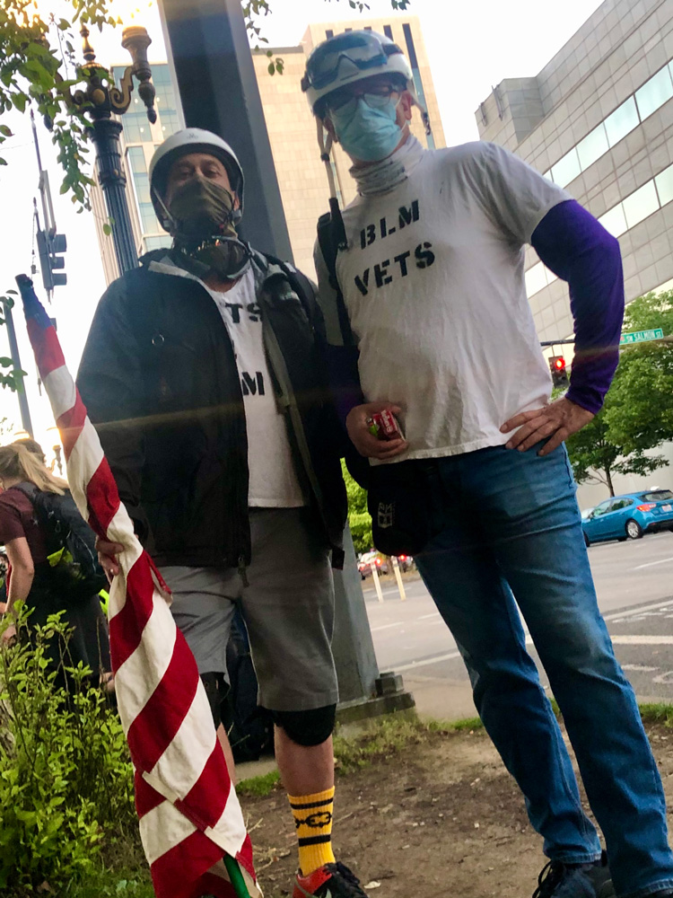 Jared Kofron and fellow veteran standing with the Wall of Vets at the Portland protests. Submitted Photo
