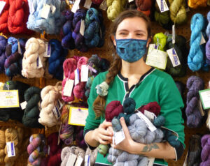 Employee Kaitlyn Maley at Apples to Oranges, Silverton's yarn shop. Photo by Melissa Wagoner