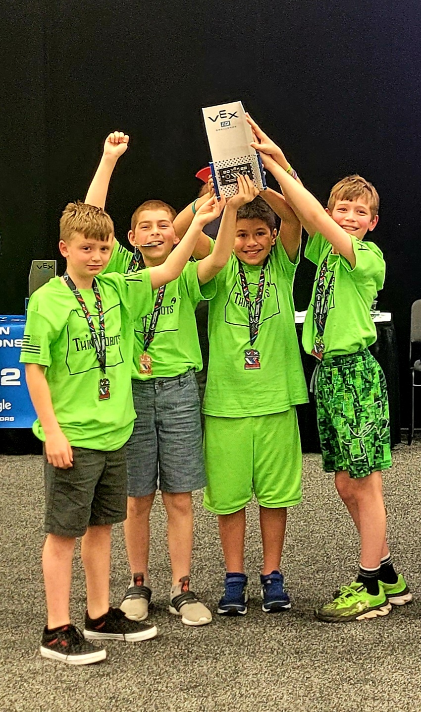 Local robot makers Noah Stoneking, left, Aiden Adams, John Lashley and Derek Schaefer, show off their trophy and medals after finishing 2nd in their division at an international event in Dallas, Texas. 