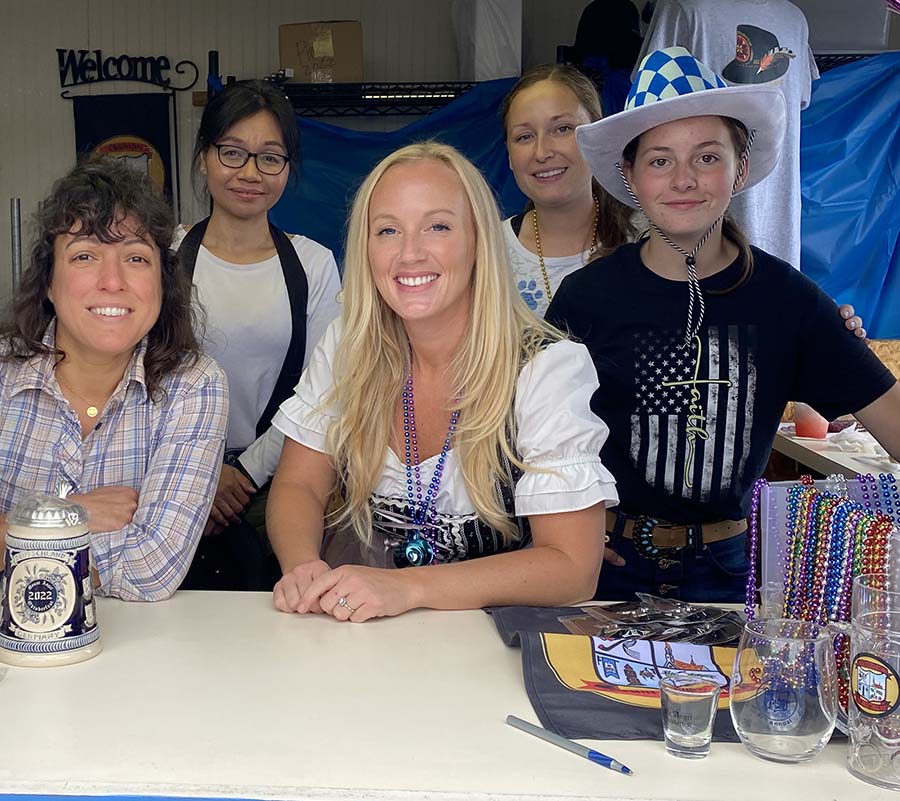 Katie Sommer, Eva Holbrok, Elizabeth Craig, Courtney and Brielle Goode in the Mt. Angel Chamber Oktoberfest booth this past September.    