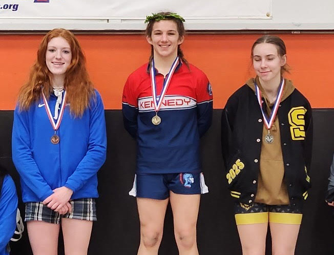 JFK wrestler Alex Geschwill stands on the top rung of the podium at last weekend’s Class 4A-3A-2A-1A regional girls wrestling tournament in Scappoose. Geschwill won the 130-pound title and moves on to the Feb. 23-24 state meet in Portland.   Submitted