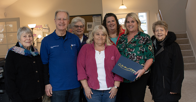 Legacy Health Auxiliary President Cheryl Lorenz (center), Treasurer George Marino (on her left), and Volunteer Manager Kay Seiler (o her right) receive the Club of the Year award from Silverton Chamber of Commerce representatives. Jim Kinghorn