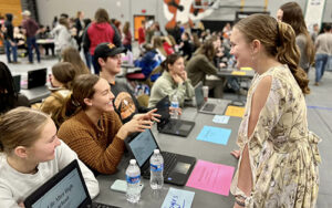 Silverton High School seniors spread out in the gym to share their Extended Application Presentations with underclassmen. The projects are a compilation of four years of activities related to choosing and pursuing a career path. Brenna Wiegand