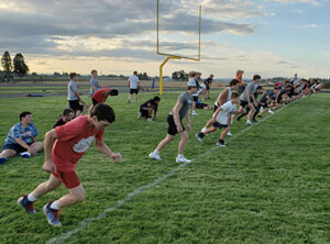 Kennedy players take off on “gassers” during their Aug. 7 workout. The Trojans open at Stanfield on Sept. 1.   James Day