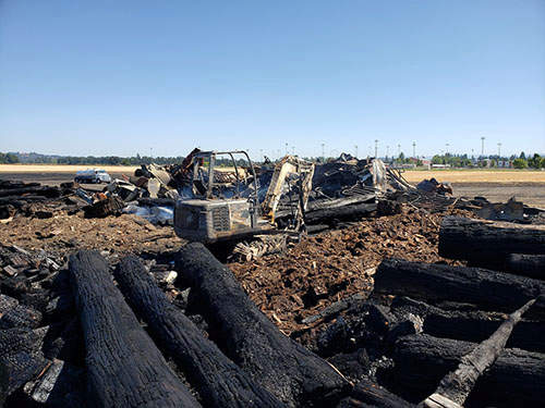 Here is a look at the smoldering aftermath of an Aug. 1 grass fire that badly damaged a firewood processing facility off of Pine Street in Silverton. James Day