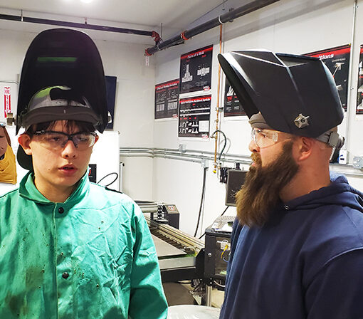 Kennedy senior welding student Oscar Gonzalez with teacher Alex Snegirev in the welding room.
