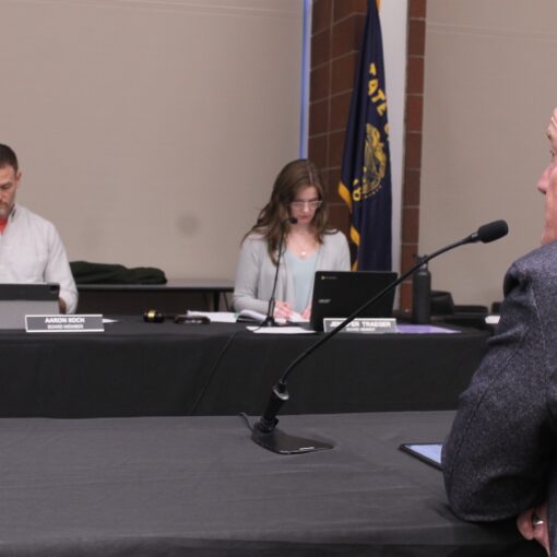 Scott Drue (foreground) resigns as superintendent of the Silver Falls School District Wednesday night during a special meeting of the SFSD Board.