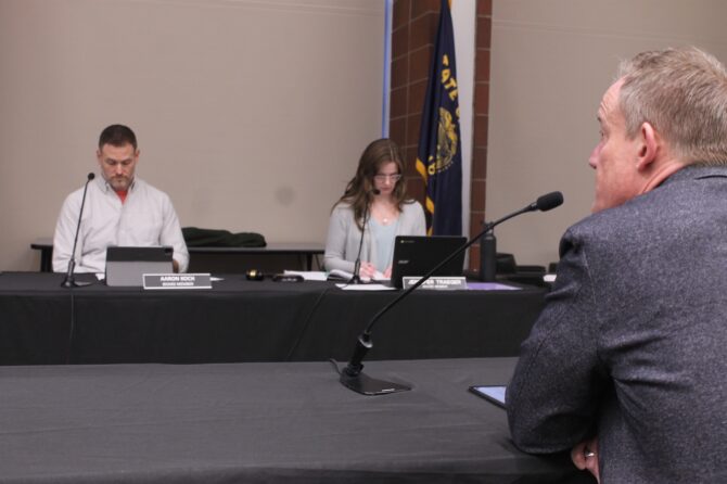 Scott Drue (foreground) resigns as superintendent of the Silver Falls School District Wednesday night during a special meeting of the SFSD Board.