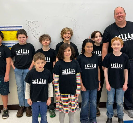 Members of the Community Roots School chess club are shown after participating in a regional tournament on Feb. 24.  Front row, from left: Abraham Hughey, Gretl Yarzak, Ramona Bahrke and Jackson Mandall. Back: Deklan Pozos, Grayson Huebsch, Jack Fenteman-Bladen, Amos Yarzak, Christopher McQueen and coach Michael McQueen. Submitted PHOTO
