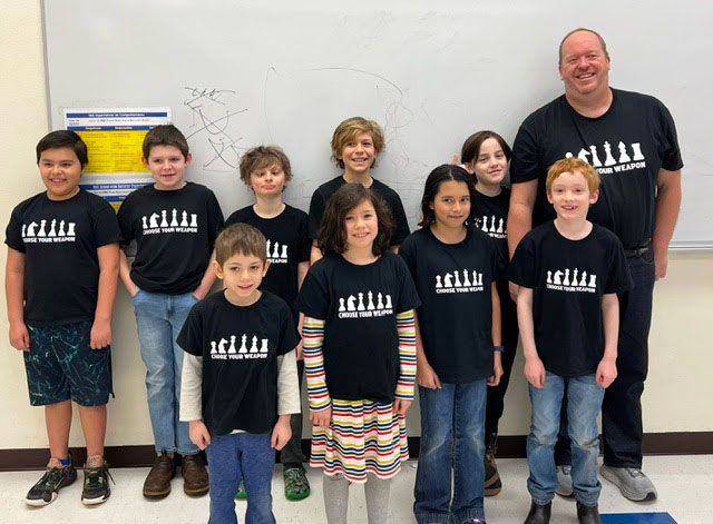 Members of the Community Roots School chess club are shown after participating in a regional tournament on Feb. 24.  Front row, from left: Abraham Hughey, Gretl Yarzak, Ramona Bahrke and Jackson Mandall. Back: Deklan Pozos, Grayson Huebsch, Jack Fenteman-Bladen, Amos Yarzak, Christopher McQueen and coach Michael McQueen. Submitted PHOTO