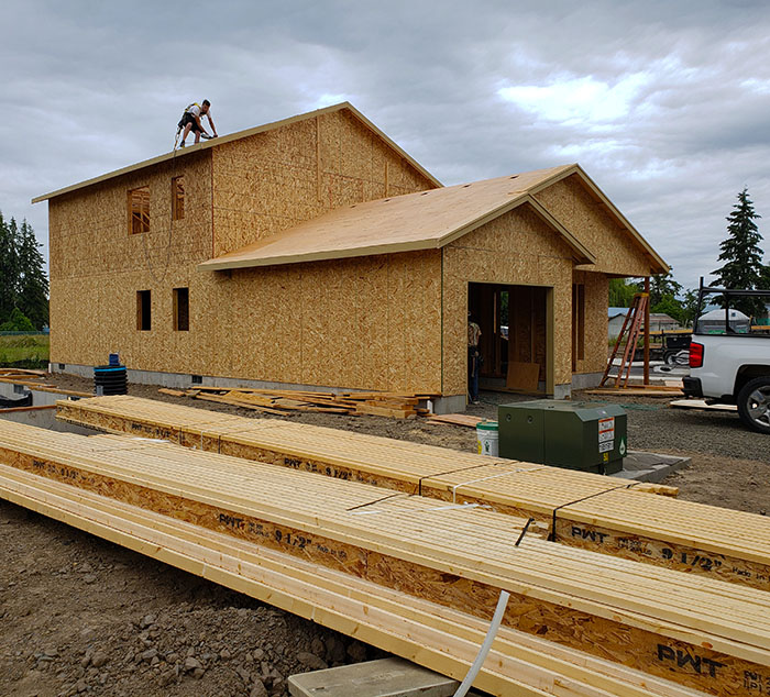 Crews work on one of the homes in the 18-unit Habitat for Humanity development on Pine Street in Silverton. Celebratory public events are scheduled for the site on June 22 and 23. James Day