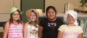 St. Mary’s Public School girls model bonnets to publicize Oregon’s Sesquicentennial festivities in Mt. Angel July 11.