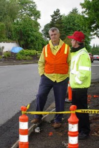 Rich Barstad, left, talks with a city employee at a recent public works project site in Silverton. He retires this month after 30 years with the city.    